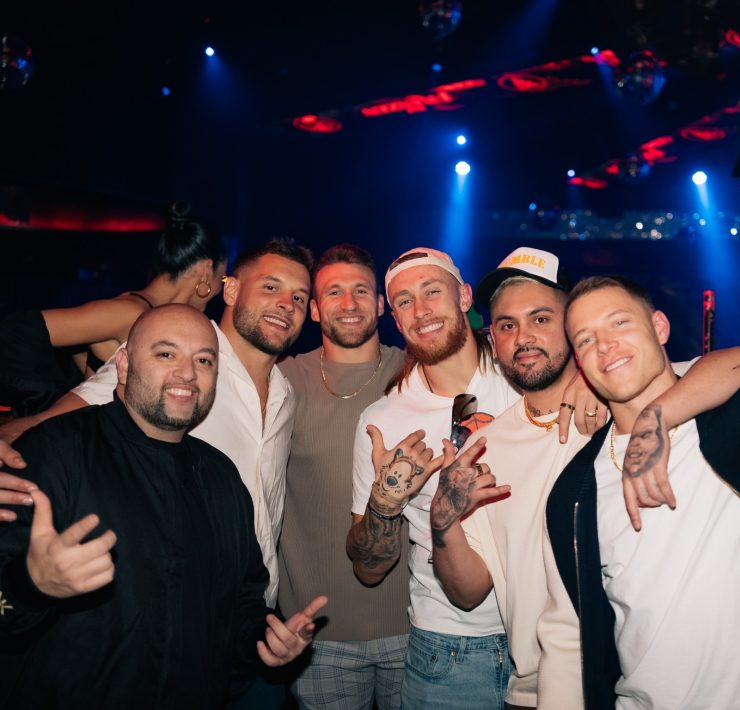 men in nightclub, football players