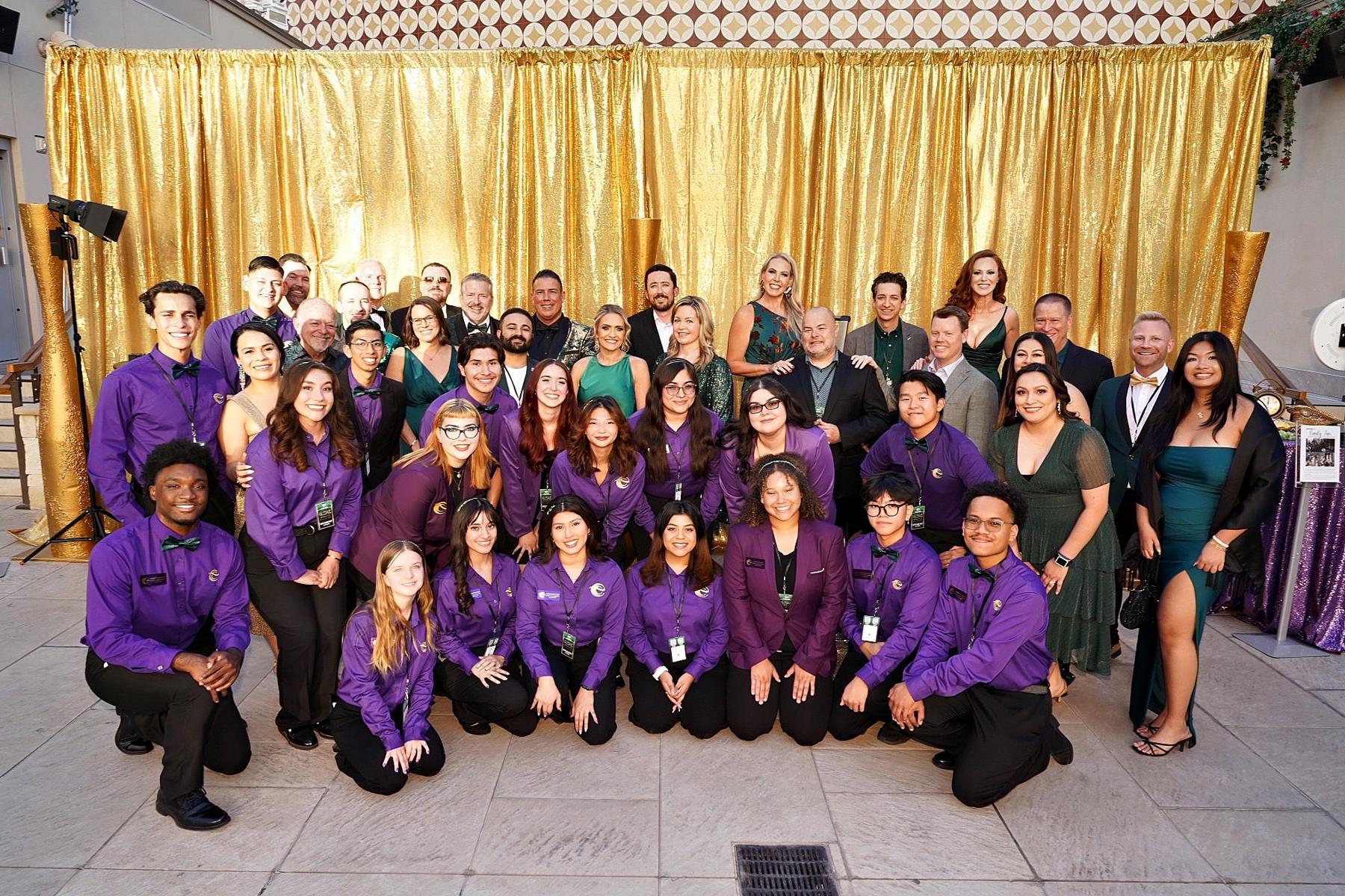 Hospitality scholarship students managing operations at a Las Vegas charity gala, gaining hands-on experience in event planning and guest services.